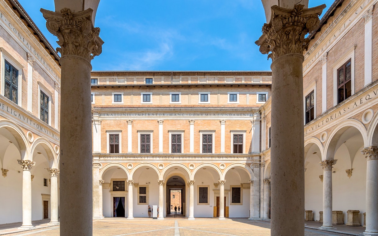 Courtyard of Ducal Palace with arches and columns, Urbino, Italy.