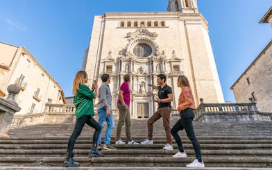 Tourists with guide in front of Girona Cathedral, Spain.