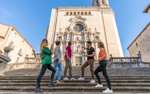 Tourists with guide in front of Girona Cathedral, Spain.