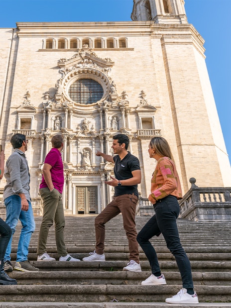 Tourists with guide in front of Girona Cathedral, Spain.