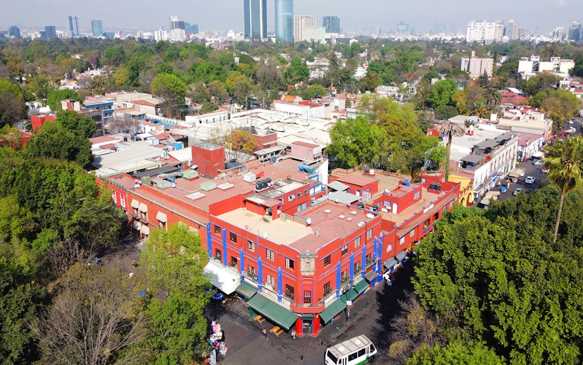 Aerial view of the historic center of Villa Coyoacan, featuring colorful buildings and lush greenery in Mexico City, CDMX.
