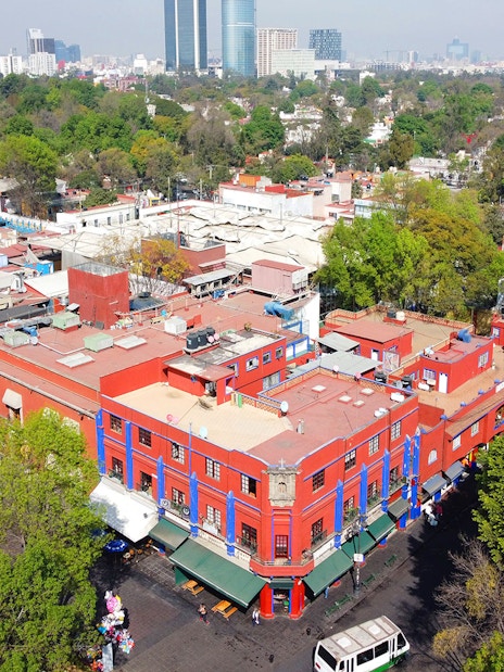 Aerial view of the historic center of Villa Coyoacan, featuring colorful buildings and lush greenery in Mexico City, CDMX.