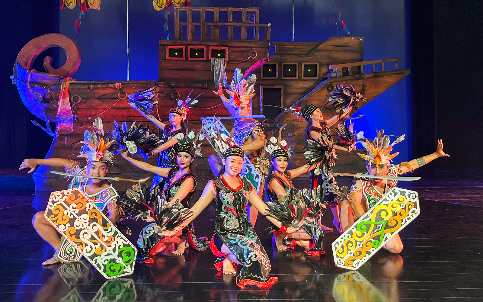 Performers in traditional costumes on stage during the Devdan Show in Bali.