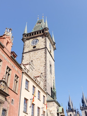Old Town Hall Tower in Prague with clock and spires against clear sky.