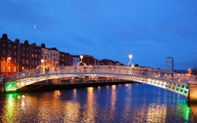 Ha'penny Bridge illuminated at night over the River Liffey in Dublin, Ireland.