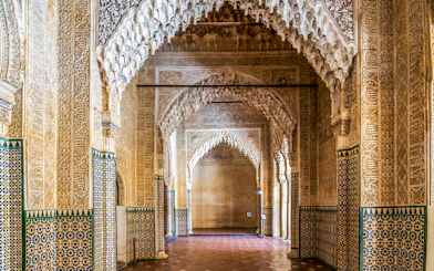 Alhambra intricate arches and tilework on guided tour in Granada, Spain.