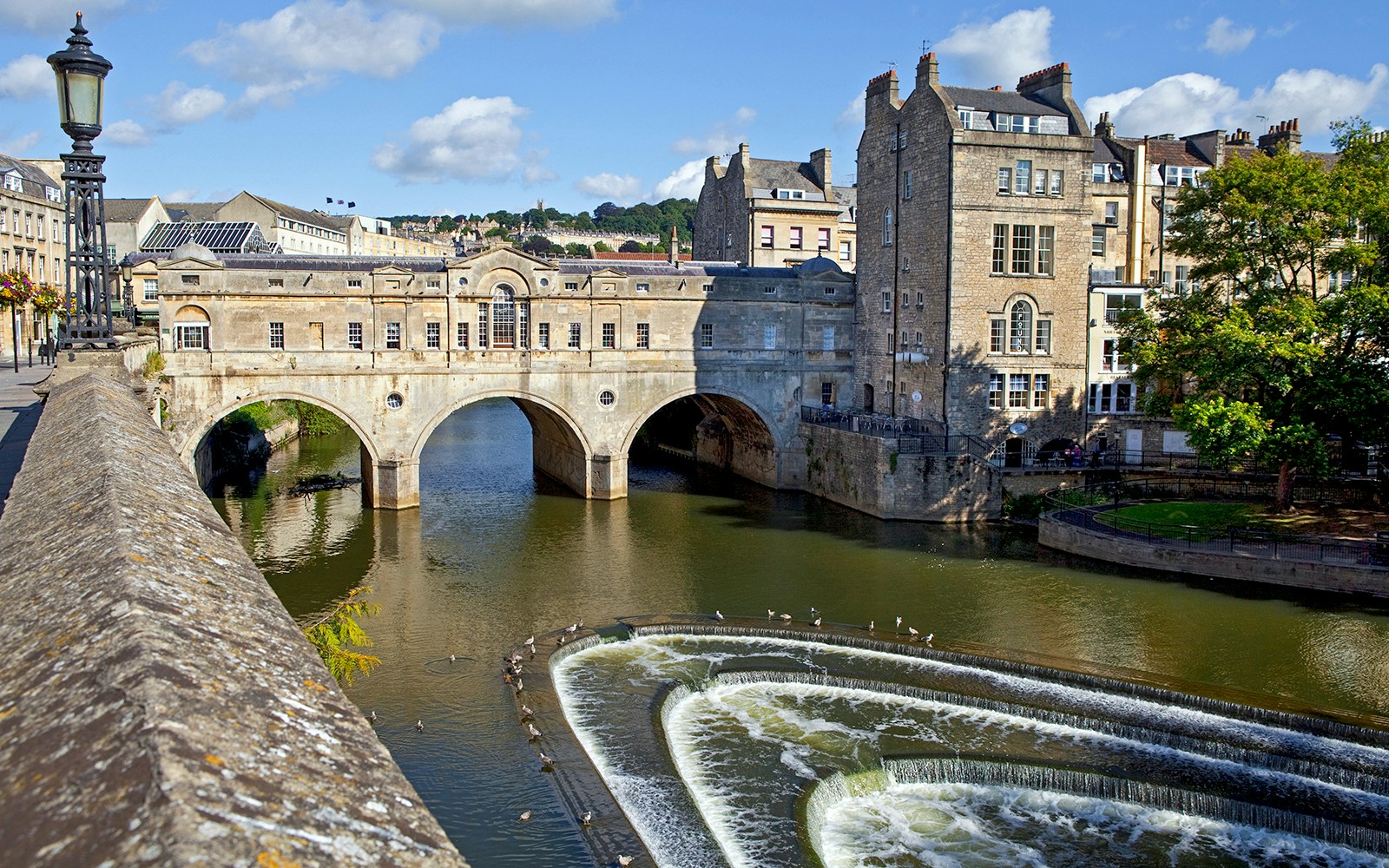 Pulteney Bridge over River Avon in Bath, featuring historic architecture and cascading weir.