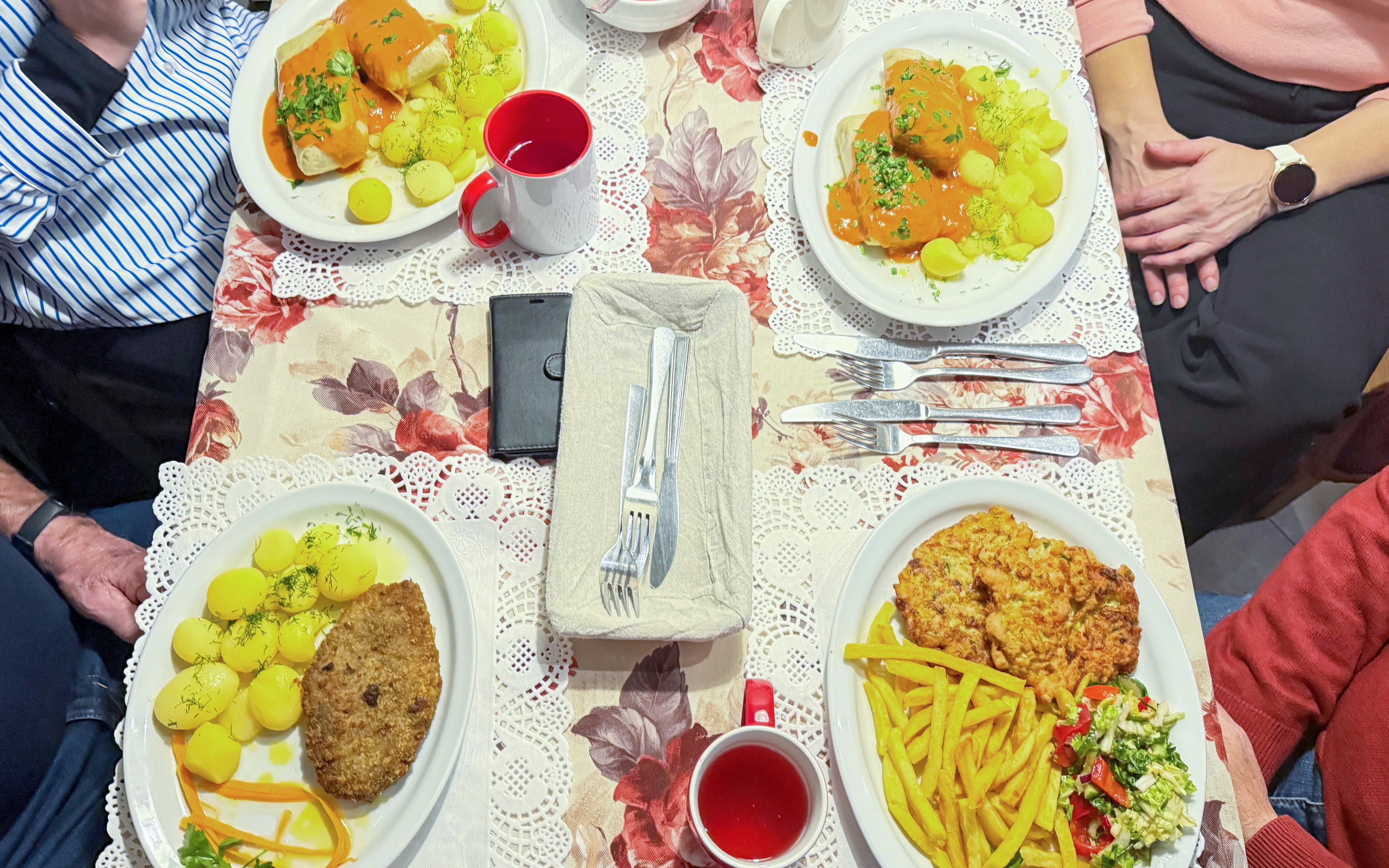 Traditional Polish meal with stuffed cabbage rolls, potatoes, and schnitzel at a Krakow restaurant.
