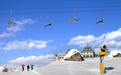 Chair-lift over skiers on snowy slope at Shahdag Mountain Resort, Baku.
