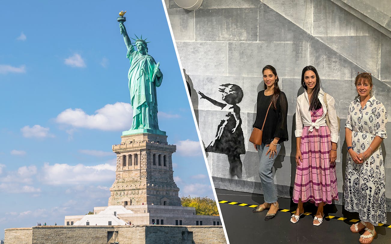 Statue of Liberty and visitors at Banksy Museum exhibit in New York City.