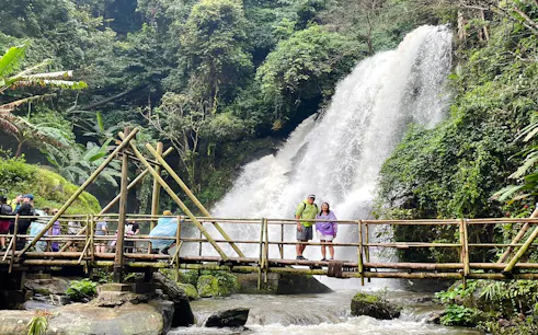 Visitors on a bamboo bridge near a waterfall in Doi Inthanon National Park, Chiang Mai.