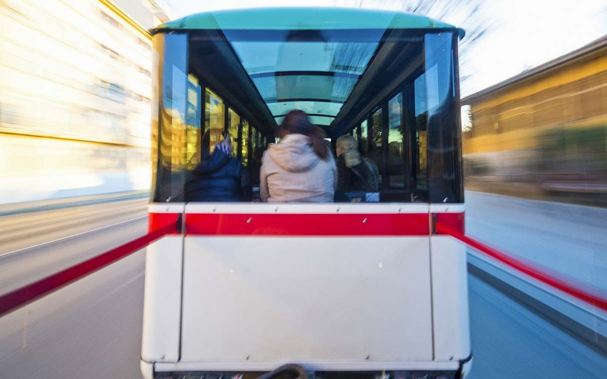 Granada city tour bus interior with passengers on a hop-on hop-off route.