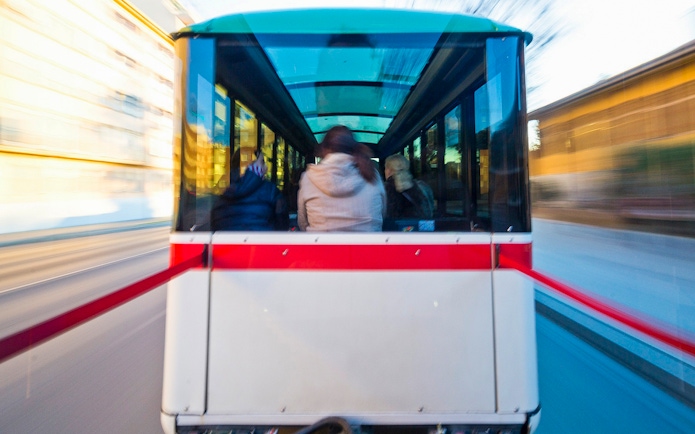 Granada city tour bus interior with passengers on a hop-on hop-off route.