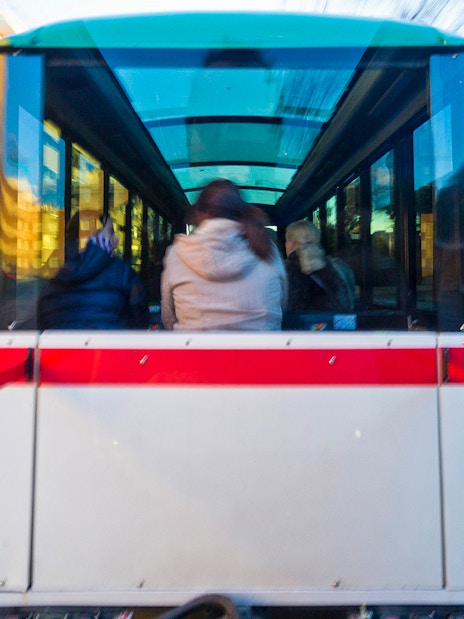 Granada city tour bus interior with passengers on a hop-on hop-off route.