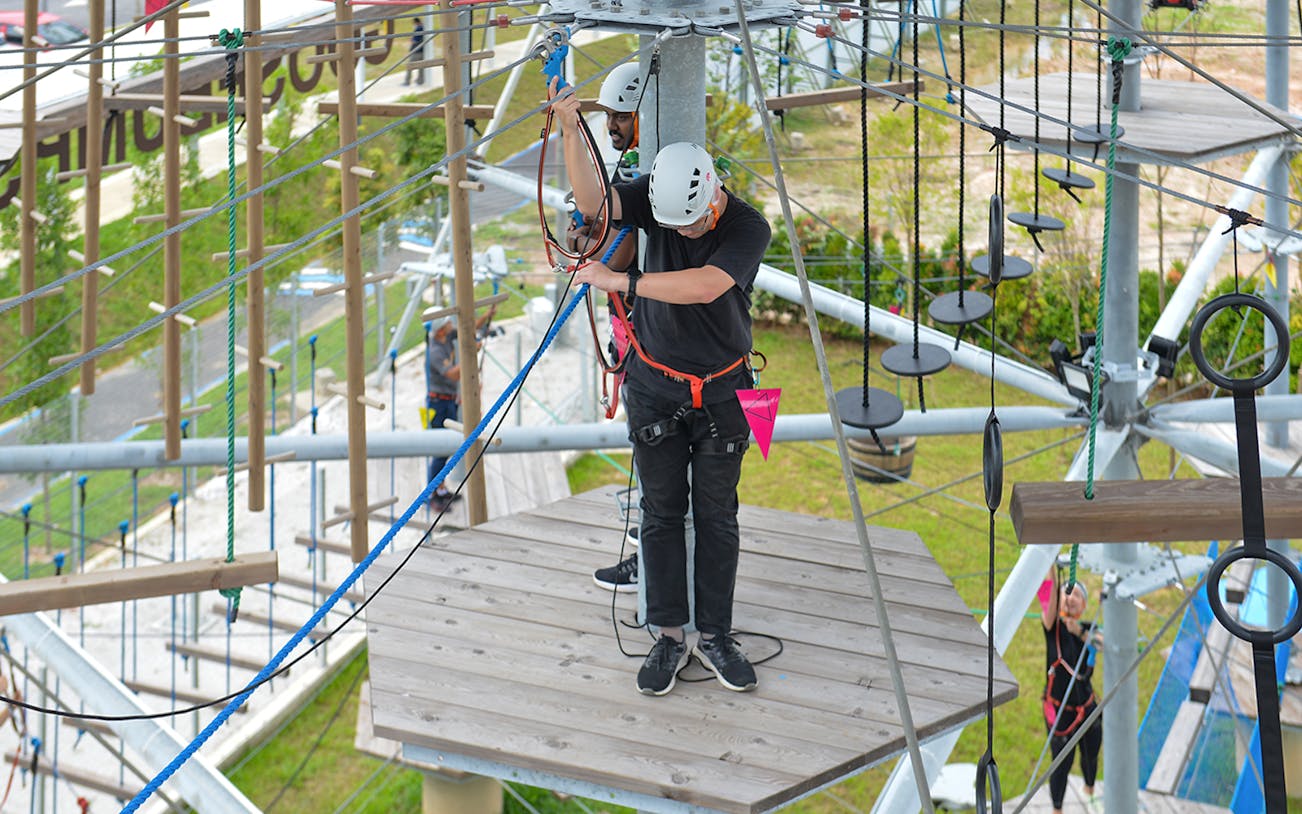 Visitors navigating a ropes course at Discovery Park, Gamuda Cove.