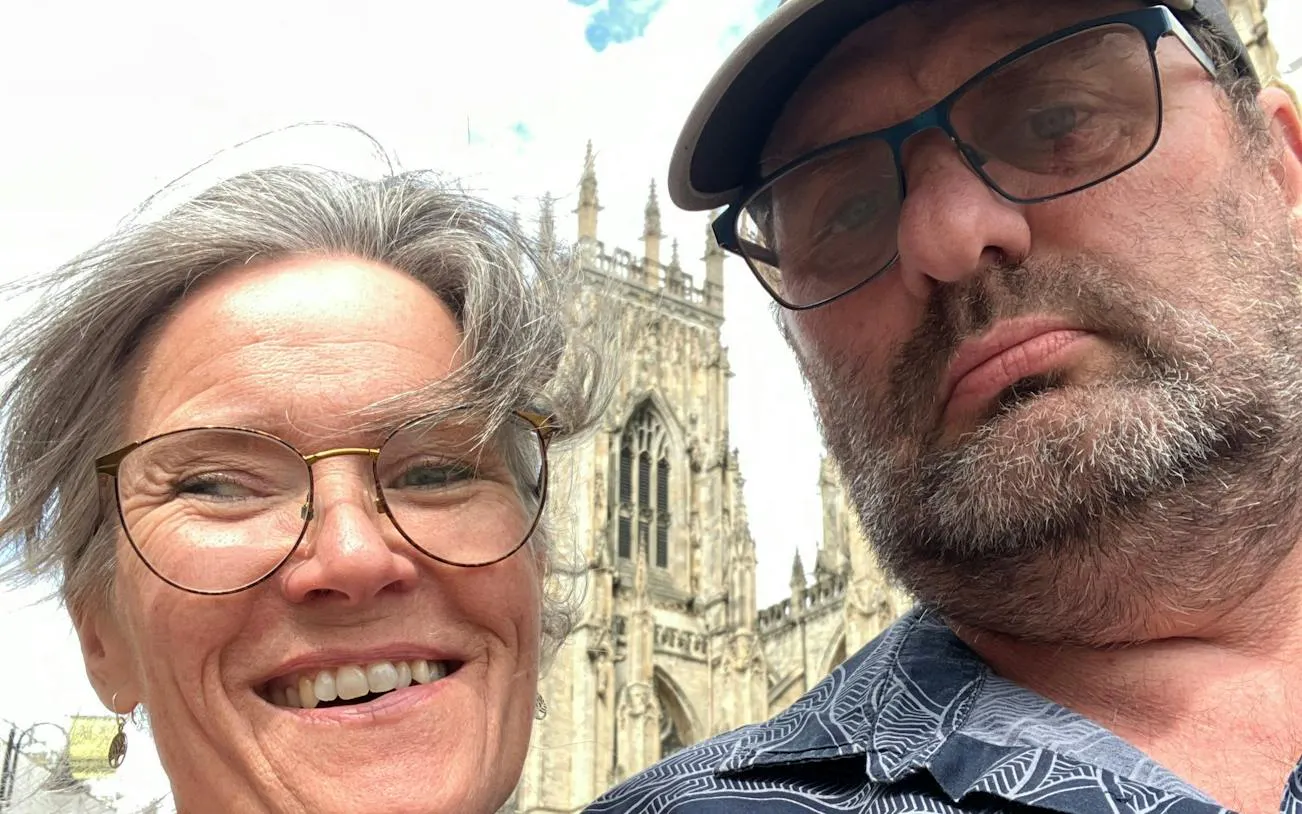 Two people in front of York Minster during a self-guided city exploration game in York.
