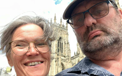 Two people in front of York Minster during a self-guided city exploration game in York.