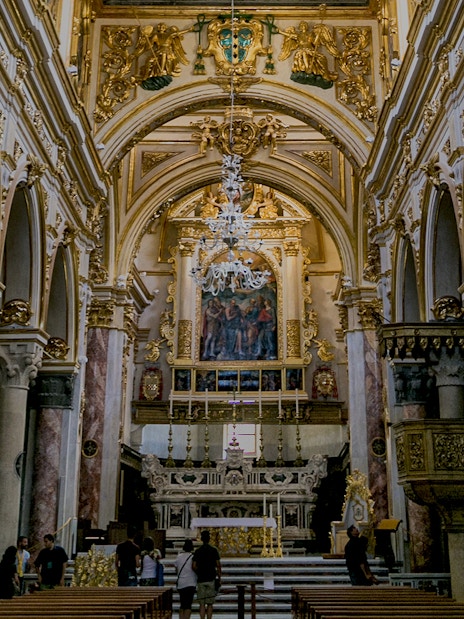 Interior of a historic church in Matera with ornate arches and altar, part of Sassi guided tour.
