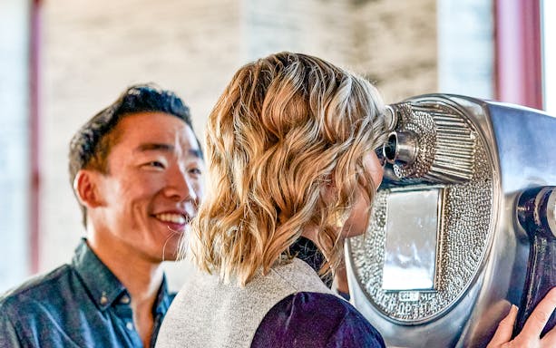 Visitors using binoculars at the 86th Floor Observation Deck, New York City.