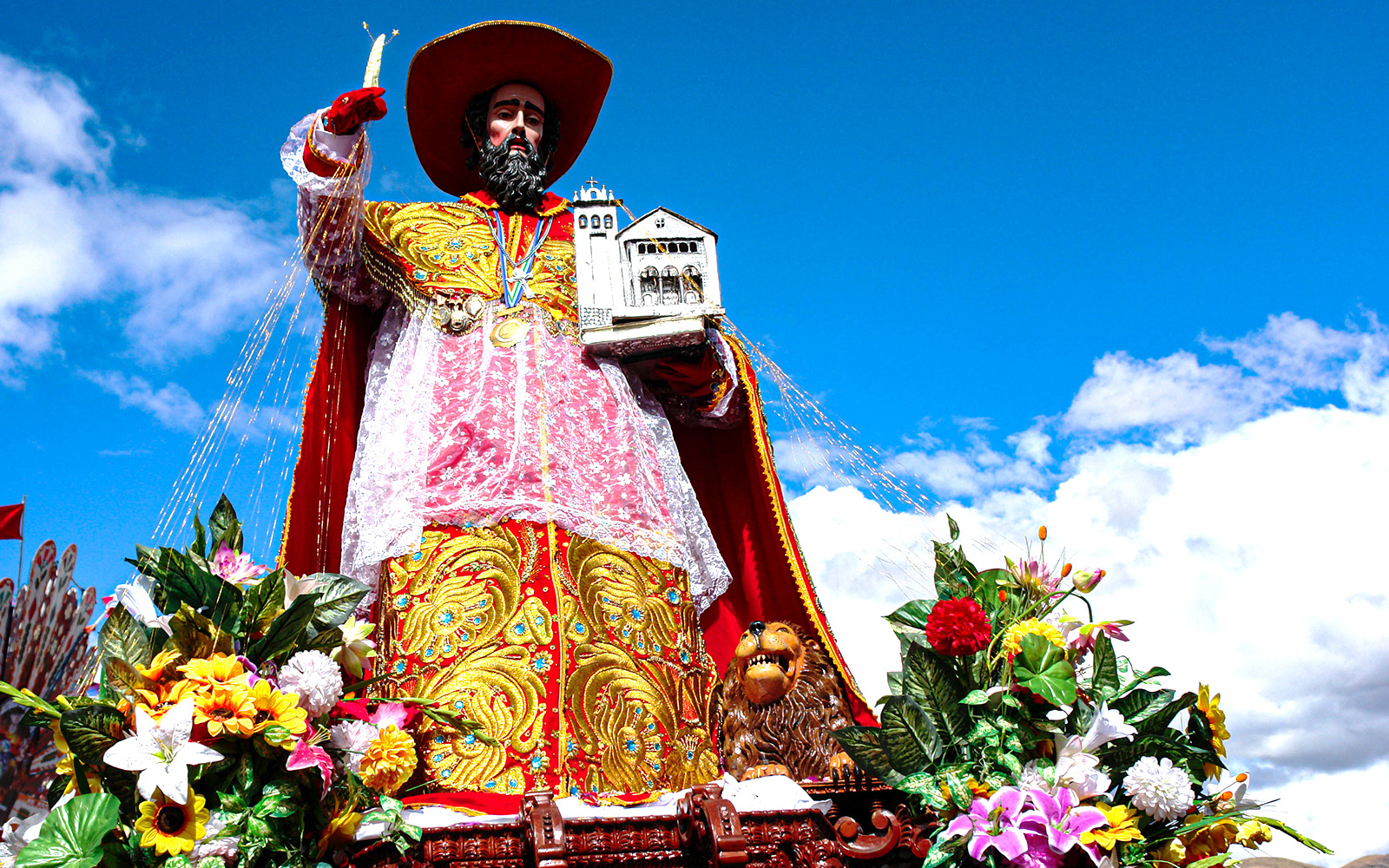 Corpus Christi procession in Toledo, Spain with colorful decorations and crowds.
