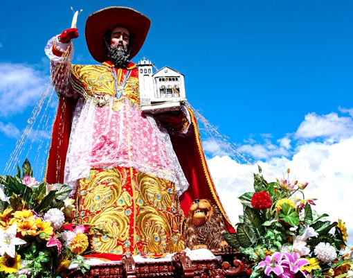 Corpus Christi procession in Toledo, Spain with colorful decorations and crowds.