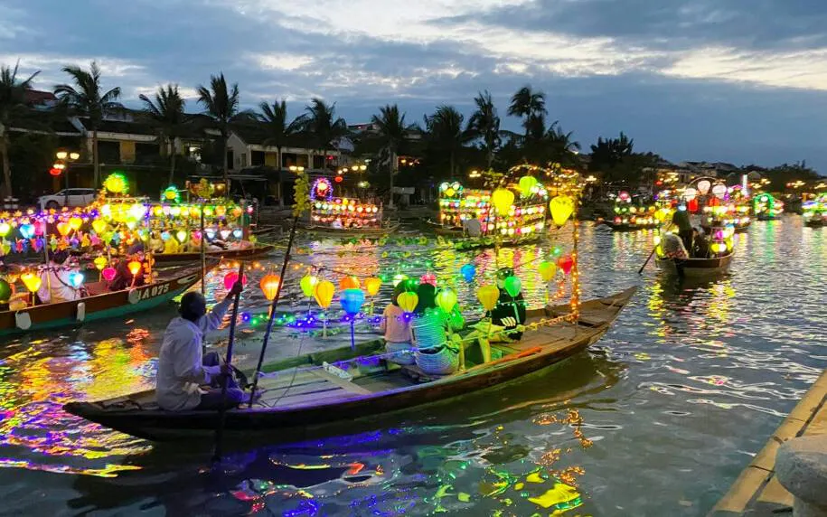 Boat ride with colorful lanterns and free herbal drink in Dubai.