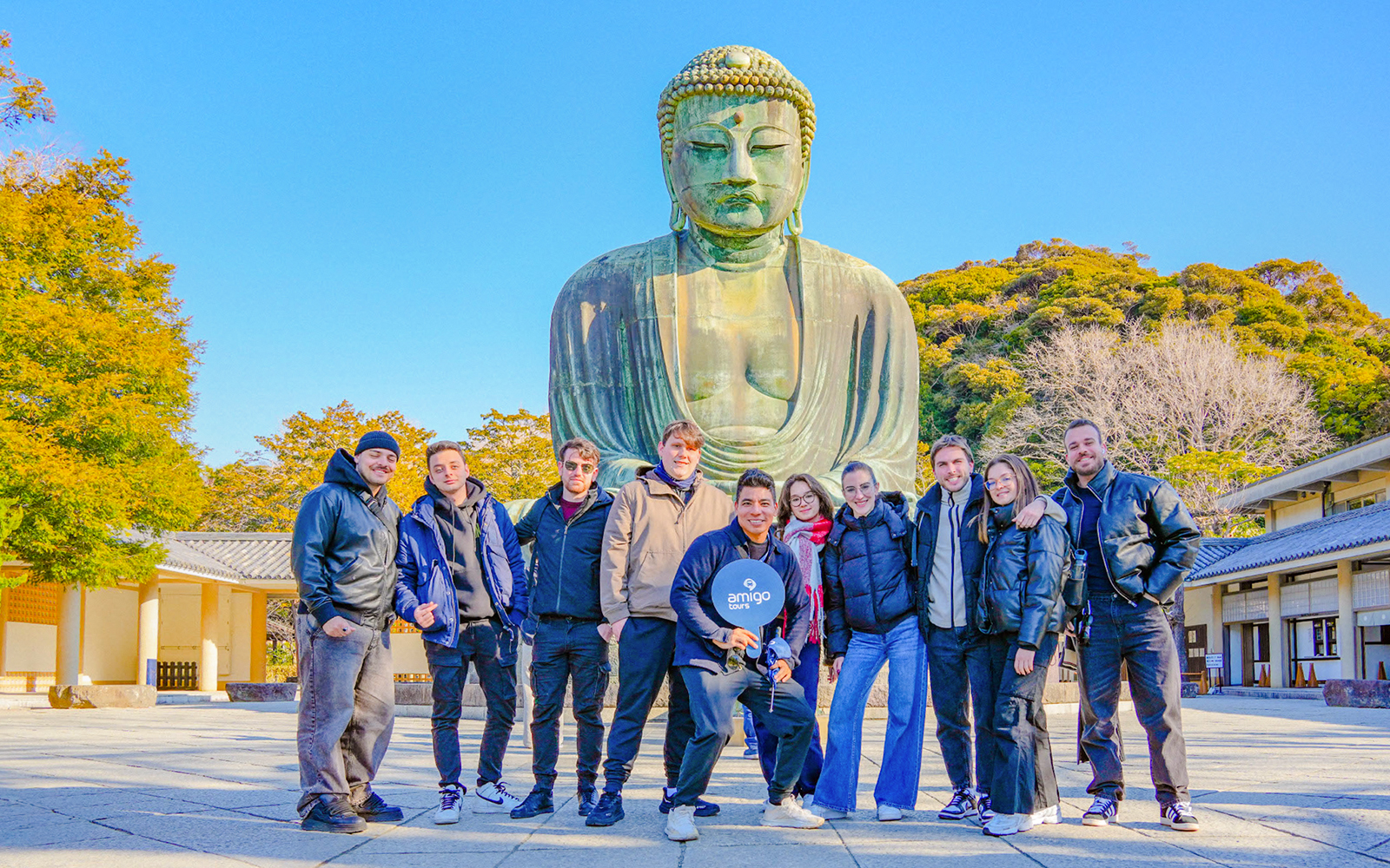Group of tourists in front of the Great Buddha of Kamakura, Japan.