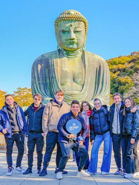 Group of tourists in front of the Great Buddha of Kamakura, Japan.