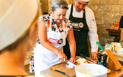 Cooking class at Neapolitan Cooking School in Sorrento with participants chopping ingredients.