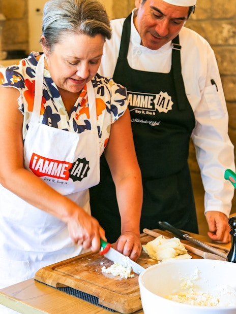 Cooking class at Neapolitan Cooking School in Sorrento with participants chopping ingredients.