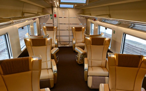 Luxurious train interior with leather seats, part of the 30-Day Italy Train Pass experience.