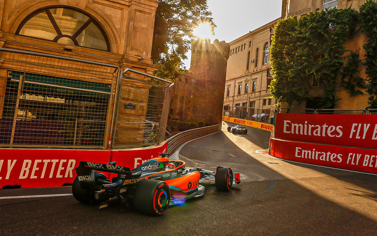 Formula 1 cars racing through Baku city streets during Azerbaijan Grand Prix.
