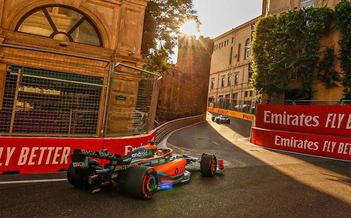 Formula 1 cars racing through Baku city streets during Azerbaijan Grand Prix.