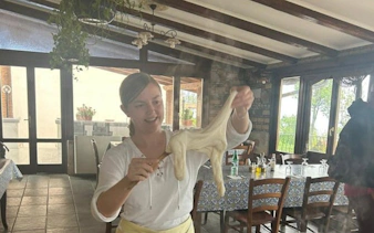 Person stretching mozzarella in Amalfi Coast farmhouse cooking class.