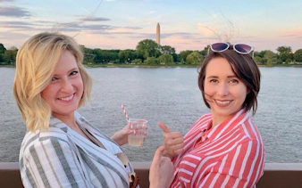 Two people enjoying a cruise on the Potomac River with the Washington Monument in the background.