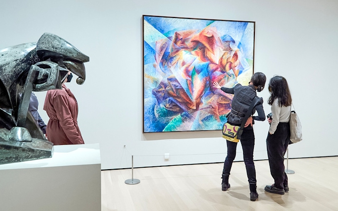 Visitors viewing abstract art and sculpture at The Museum of Modern Art (MoMA).