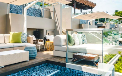Twelve Beach Club cabana with seating area and poolside view.