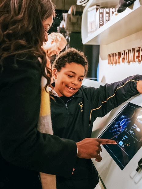 Visitors interacting with a digital display at Battersea Power Station's Lift 109 experience.