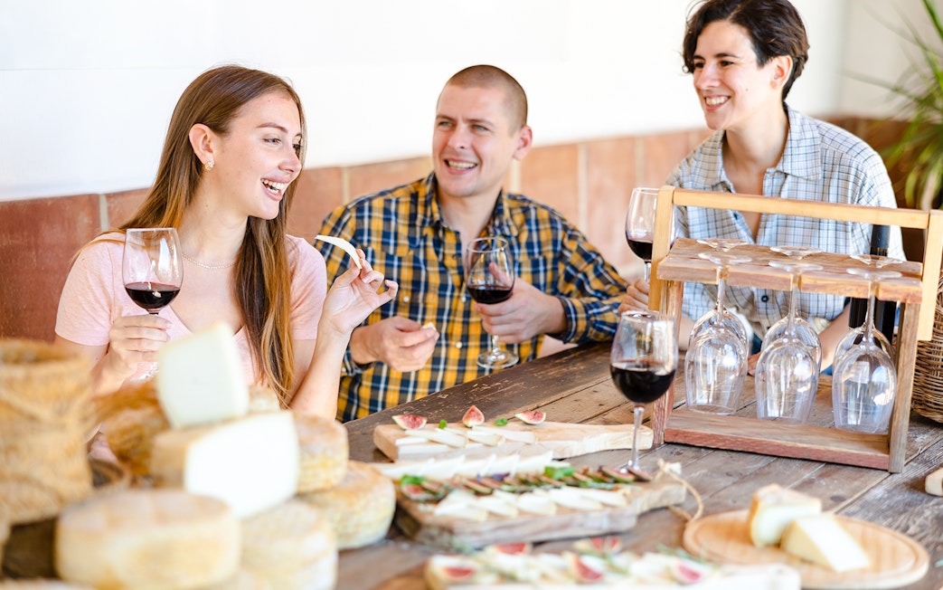 Guests enjoying wine and cheese at Cheese Museum in Paris.