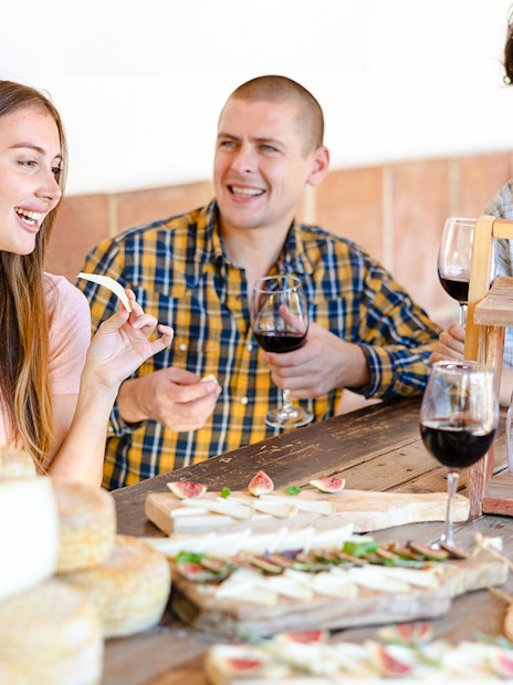 Guests enjoying wine and cheese at Cheese Museum in Paris.