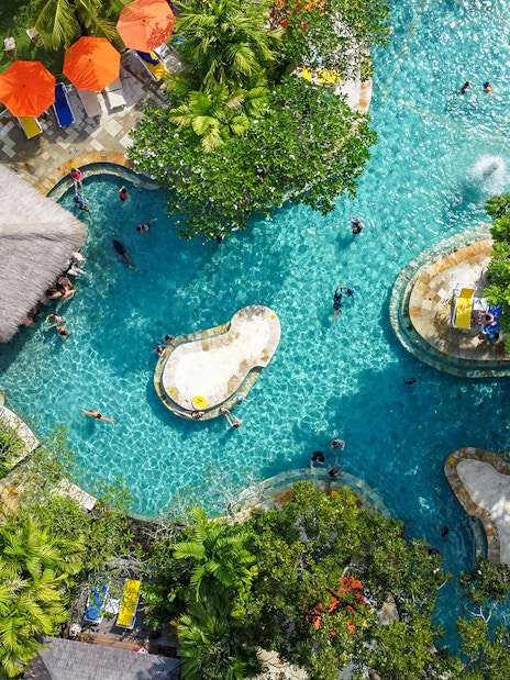 Aerial view of the Pleasure Pool at Waterbom Bali with sun loungers and umbrellas.