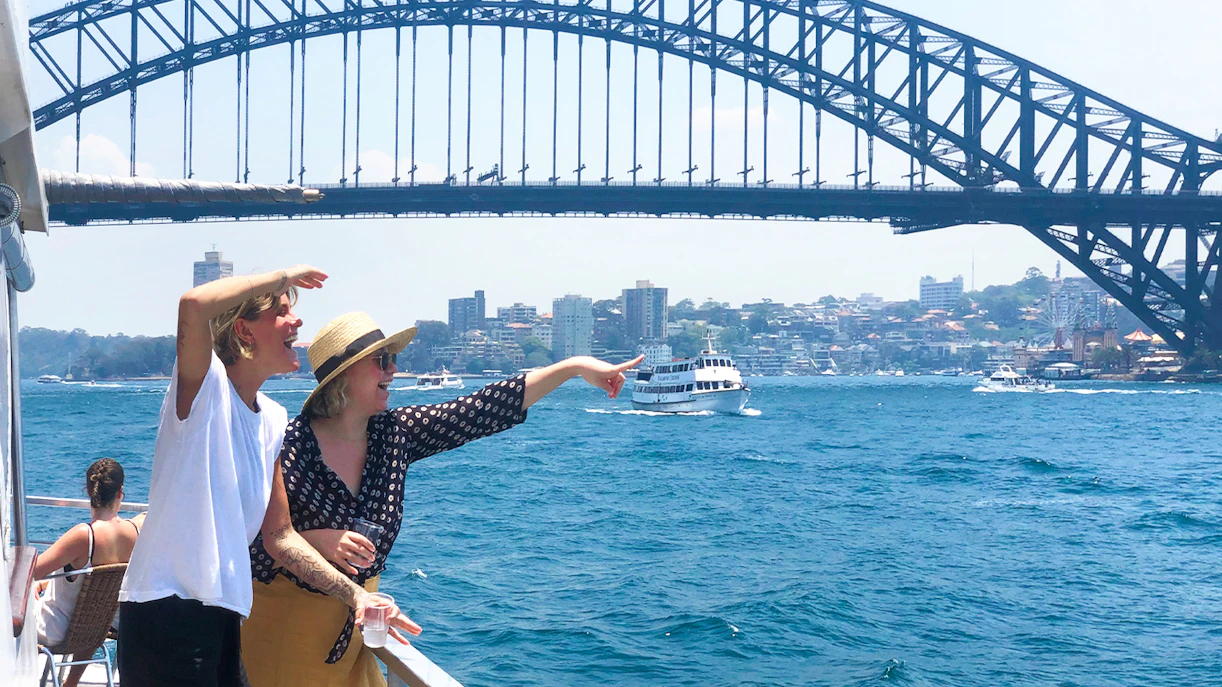 Passengers enjoying views of Sydney Harbour Bridge on a discovery cruise.