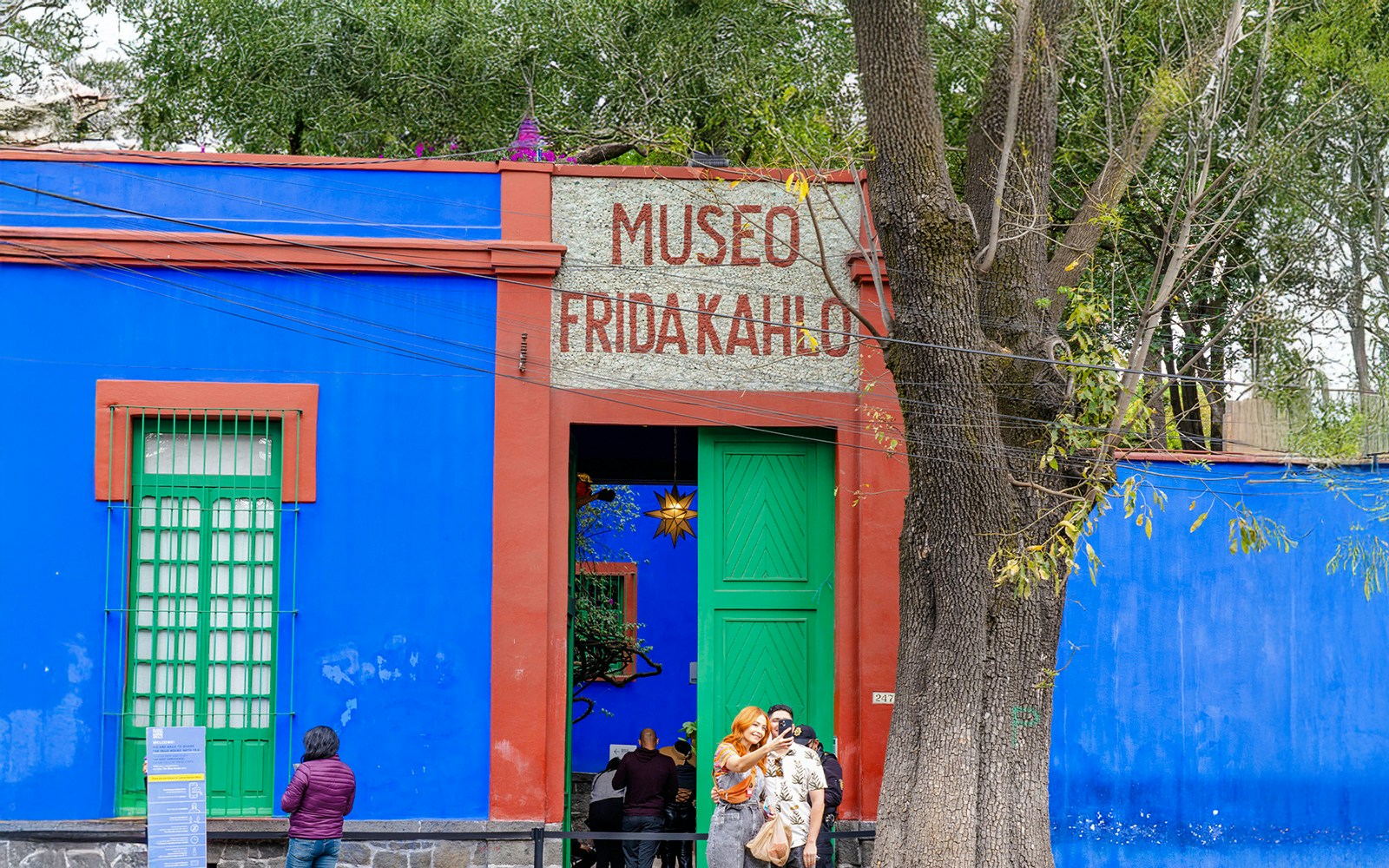 Frida Kahlo Museum entrance with visitors in Coyoacán, Mexico City.