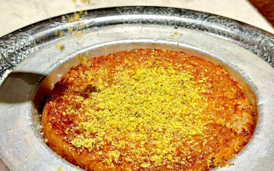Kunafa dessert with pistachios served in a metal tray, Istanbul.