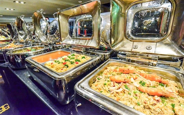 Buffet selection on Chao Phraya Princess dinner cruise with pasta and seafood dishes.