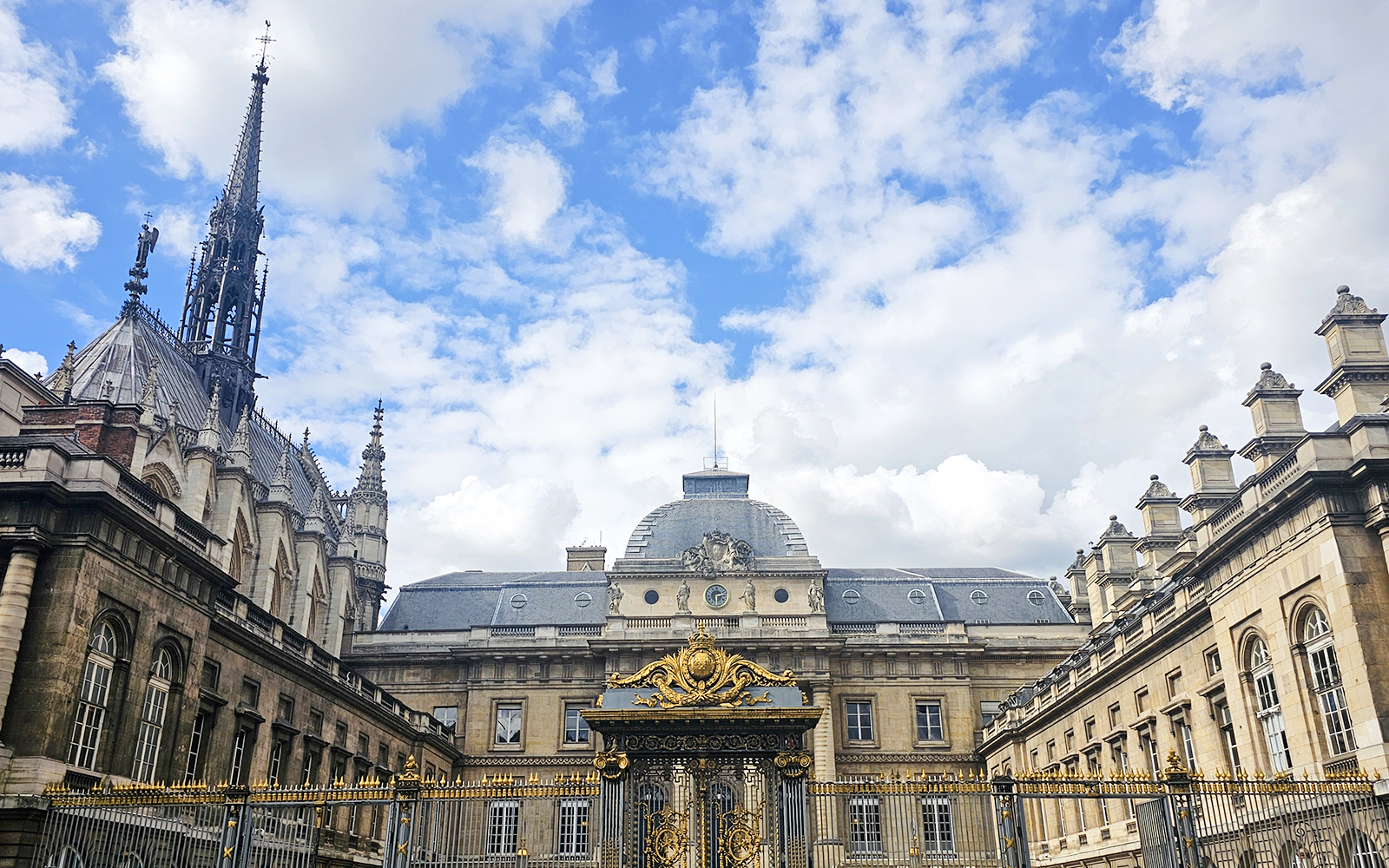 Sainte Chapelle exterior with ornate spire and decorative gate in Paris, France.