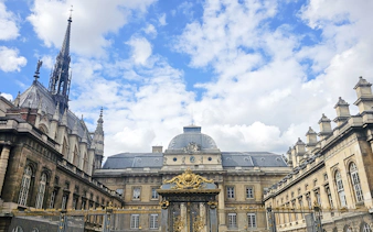 Sainte Chapelle exterior with ornate spire and decorative gate in Paris, France.