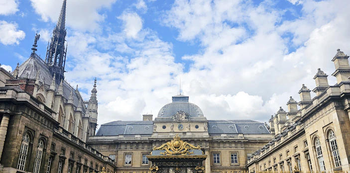 Sainte Chapelle exterior with ornate spire and decorative gate in Paris, France.