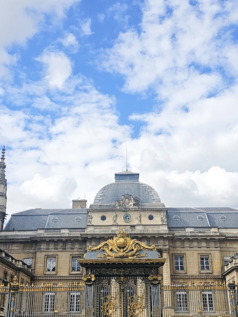 Sainte Chapelle exterior with ornate spire and decorative gate in Paris, France.