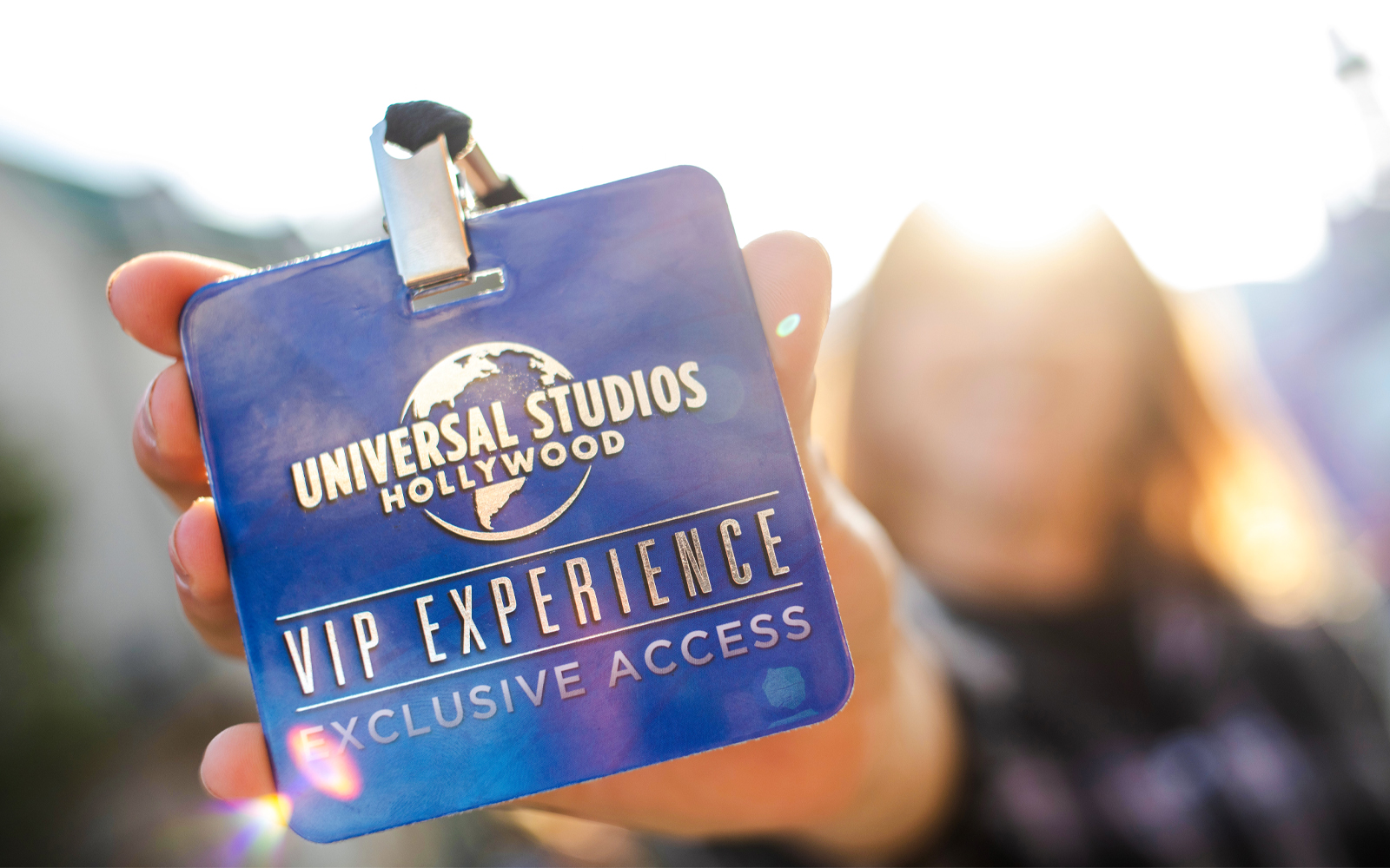 Universal Studios Hollywood VIP Experience badge held in hand.